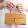 box shaped bamboo handbag, inspired by treasure chests, 100% bamboo material, unique and eye-catching accessory