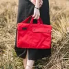 canvas working bag, multiple separate compartments, fits a laptop, can be worn crossbody or carried by hand