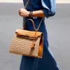 knitted bag with leather padlock, woven straw with leather trim material, subtle brown tone, modern young design, suitable for every outfit