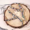 dark blue ceramic bead ankle lace, pastel-toned ceramic beads, wrapped from ankle to foot, standout fashion accessory