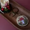 handmade red mushroom wooden keychain, hand-embroidered amanita muscaria mushroom, deep tone, a gift for vintage style enthusiasts