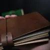 The Veg Tan Journal (23x12cm) is a genuine leather notebook with a classic and elegant style, featuring hand-dyed leather and decorative charms, making it a unique corporate gift for any occasion