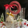 The "A Bag of Joy" Christmas Gift Set, bursting with youthful fun, is a transparent gift basket featuring a ceramic mug, cocoa, and marshmallows, making it a unique Christmas gift perfect for spreading holiday cheer