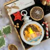 The "Light Up The Night" Christmas Gift Box is the perfect way to warm up the holiday season, featuring a gift set with a scented candle, lamp, and chocolate ornament, making it an ideal corporate gift set to spread festive cheer