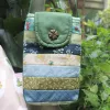 The Magpie Robin Phone Bag, with its vibrant and vintage colors, is a charming handmade patchwork phone pouch, doubling as a mini crossbody bag and making it a perfect vintage handmade accessory and thoughtful gift for her