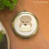 The Hand-Embroidered Mirror, with its captivating design and 25cm diameter, offers a personalized touch, making it a unique handmade accessory and a perfect birthday gift that tells a special tale