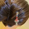 The Lotus Tassel Dangle Wooden Hair Stick enhances your hair with a touch of grace, offering a beautiful blend of traditional style and vintage charm, making it a unique gift for her