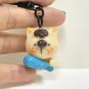 The Handmade Clay Cat Hugging Fish Keychain boasts a charming look that everyone adores, making it a lovely accessory - a handcrafted bag charm and clay keychain that's the perfect cute gift for her