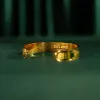 The "Cat & Box" Metal Cuff Bracelet With Hand-Painted Leather is a handmade fashion accessory that beautifully highlights individuality, making it a perfect birthday gift for her.