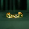 The "Cat & Box" Metal Cuff Bracelet With Hand-Painted Leather is a handmade fashion accessory that beautifully highlights individuality, making it a perfect birthday gift for her.