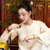 Áo dài vải thêu họa tiết lược tinh tế, tôn lên nét sang trọng của quý cô hiện đại — món quà lưu niệm đậm chất Việt với vẻ đẹp truyền thống.