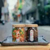 Candied pomelo pith and honey kumquat gift box delivers rich authentic flavors in traditional checkered scarf-wrapped packaging, offering Vietnamese specialty treats as healthy snacks and wellness gifts