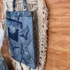 Slim bottom tote crafted from old jeans creates an exclusively yours accessory, combining upcycled materials with fashion-forward design as sustainable fashion statement and meaningful eco-friendly handmade gift