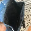 Floral flap backpack from old jeans adds an elegant fashion statement touch, creating a one-of-a-kind upcycled accessory and unique handcrafted birthday gift.