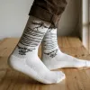 White cotton crew socks with Salaxsaler’s exclusive signature, crafted from soft thick cotton and hand-silkscreened—perfect travel socks, stylish fashion accessory, and unique souvenir.