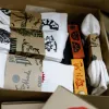 White cotton crew socks with Salaxsaler’s exclusive signature, crafted from soft thick cotton and hand-silkscreened—perfect travel socks, stylish fashion accessory, and unique souvenir.