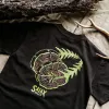 The "Here To Hear" cotton T-shirt connects nature and time with a creative design and comfortable fabric, perfect for travel, adventures, or as a birthday gift.