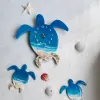 Turtle Family epoxy resin wall clock, handmade and unique, perfect as an impressive housewarming gift and for children.