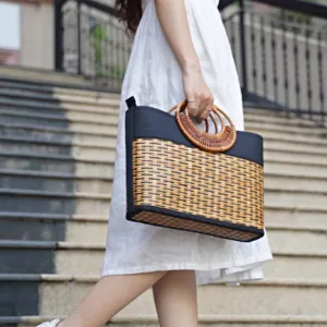 medium rectangular bamboo woven-handle bag, luxurious smooth black leather trim, simple and elegant style, unique loop handle