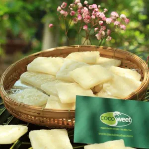 young coconut candy, vietnamese specialty, sweet chewy coconut candy, sprinkled with white sesame seeds, served with tea, gift for friends