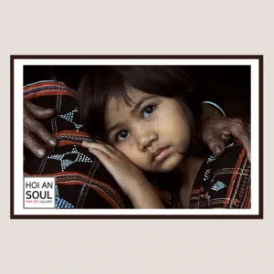 “in grandma’s arm” photograph, a photo of a co tu girl with big round eyes, evoking a gentle and warm feeling