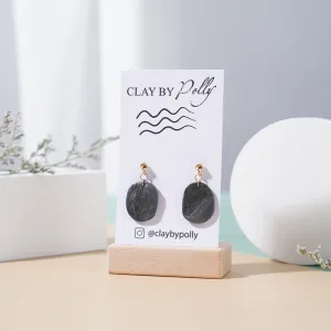 small black stone earrings in color metallic black, elegant and sophisticated style, classic teardrop design, mysterious black stone details