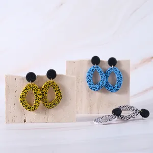 cow print abstract round shaped clay earrings, unique and eye-catching design, personalized fashion accessory, facial highlight