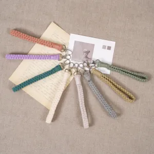 buttercup macrame keychain, pastel colors, minimalist monochrome design, sturdy woven fiber material, can be worn as a wristband