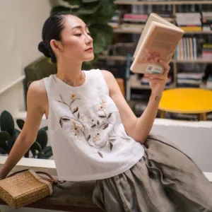 white sleeveless fuuka top with embroidered flowers, floral mai pattern, feminine style, lightweight material, comfortable design