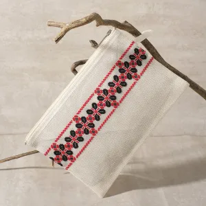 white clutch with embroidered petals, fashionable clutch design, durable textilene material, embroidered flower wings pattern