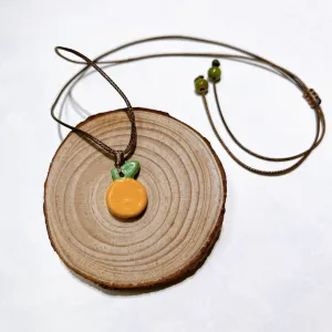 citrus ceramic necklace, glazed ceramic material, unique necklace, adds a pop of color to monochrome outfits