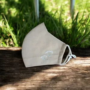 The Dandelion Embroidery Linen Face Mask combines a delicate look with eco-friendly charm, featuring adjustable straps, a handmade design, and a 3-layer protective structure—making it the perfect sustainable accessory