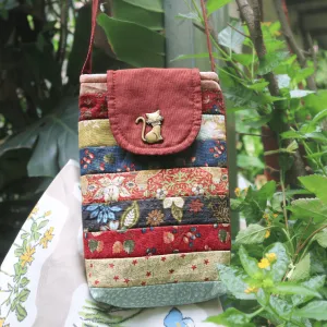 The Magpie Robin Phone Bag, with its vibrant and vintage colors, is a charming handmade patchwork phone pouch, doubling as a mini crossbody bag and making it a perfect vintage handmade accessory and thoughtful gift for her