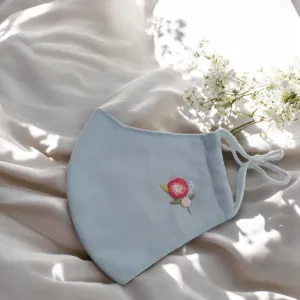 The Two-Rose Embroidery Linen Face Mask showcases the charming beauty of delicate craftsmanship, featuring an adjustable design, 3-layer construction, and eco-friendly materials, making it the perfect handmade accessory for both style and sustainability.