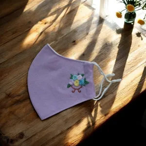 The Rose Basket Embroidery Linen Face Mask is a charming and eco-friendly accessory, thoughtfully handmade with a 3-ply design, adjustable straps, and natural linen for comfort and style