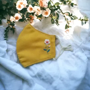 The Rose Embroidery Face Mask perfectly blends vintage vibes with modern style, featuring a handcrafted linen design, adjustable straps, and a 3-layer construction, making it a unique accessory for anyone seeking both elegance and comfort.