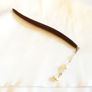 The Lily Orchid Dangle Wooden Hair Stick features a delicate and airy design that not only keeps your hair in place but also serves as an elegant handmade accessory, making it the perfect gift for her