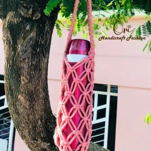 The Knitted Mesh Bottle Bag is a charming handmade accessory that gives your everyday bottle a stylish upgrade - featuring a crochet bottle holder and macrame bottle bag design, making it a practical yet adorable birthday gift for any occasion