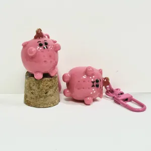 The Handmade Clay Heart-Hat Pig Keychain is an adorably heartwarming bag charm accessory, making it a lovely handmade gift for friends who love unique and cute designs.