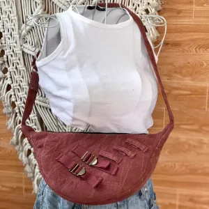 Dark pink half-moon crossbody bag from old jeans amplifying personal style, featuring premium upcycled jeans bag design as a creative birthday gift for sustainable fashion