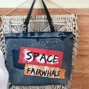 Space tote bag from old jeans captures the vibrant imprint of modern fashion through sustainable recycled denim, creating a unique fashion accessory that makes an impressive handmade birthday gift.