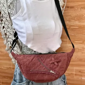 Pink half-moon crossbody bag from old jeans features one-of-a-kind color palette, creating a denim upcycled accessory and unique birthday gift for eco-conscious fashion loversPink half-moon crossbody bag from old jeans features one-of-a-kind color palette, creating a denim upcycled accessory and unique birthday gift for eco-conscious fashion lovers