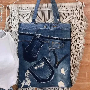 Slim tote bag from old jeans featuring impressive unique fabric combinations, creating a distinctive fashion handbag that serves as both a sustainable fashion accessory and thoughtful handcrafted gift.