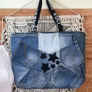 Five-star tote bag from old jeans highlights eco-fashion excellence through creative upcycling, functioning as both practical accessory and meaningful handmade gift.