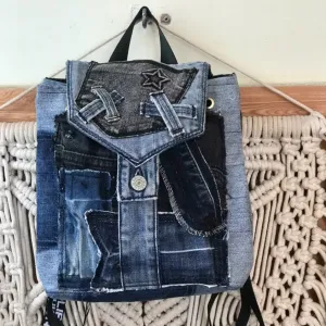 Diagonal pattern mini backpack repurposed from old jeans features bold linear elements, combining denim style with durable fabric construction as sustainable fashion accessory and uniquely creative handcrafted birthday gift