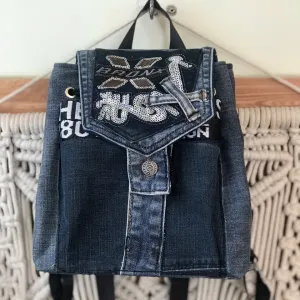 Mini backpack from old jeans features playful glittery decorations, combining drawstring convenience with fashion-forward design as sustainable accessory and thoughtful handcrafted gift