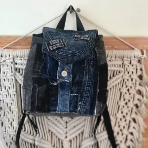 Rugged style mini backpack crafted from old jeans creates street fashion eye-catching impact with convenient drawstring design, serving as sustainable fashion accessory and creative birthday gift