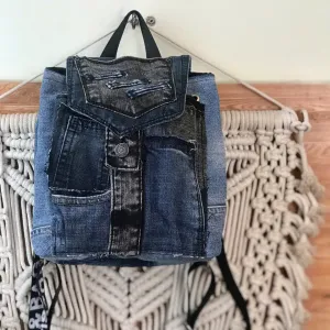 Flap mini backpack crafted from old jeans offers exclusive one-off design just for you, combining upcycled fashion sensibility with distinctive denim style as creative birthday gift and meaningful eco-friendly present.