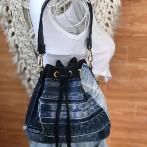 Blue-accented bucket bag from old jeans makes sustainable fashion's bold statement with convenient drawstring design, creating an upcycled jeans bag and creative birthday gift