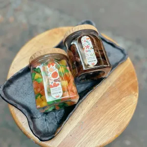 Candied pomelo pith and honey kumquat gift box delivers rich authentic flavors in traditional checkered scarf-wrapped packaging, offering Vietnamese specialty treats as healthy snacks and wellness gifts